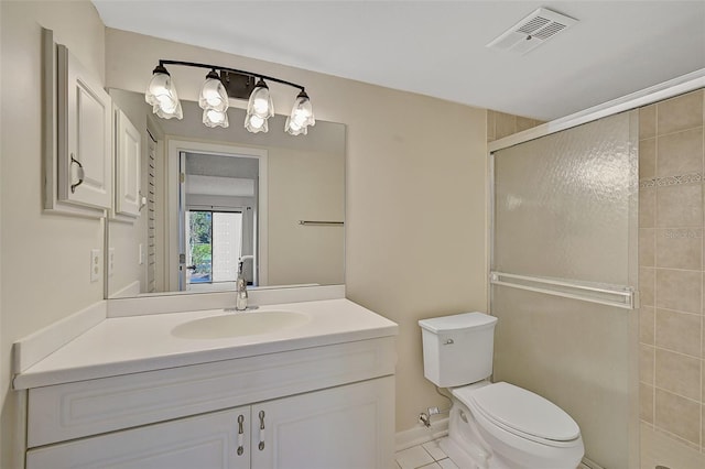 bathroom featuring tile patterned floors, vanity, an enclosed shower, and toilet