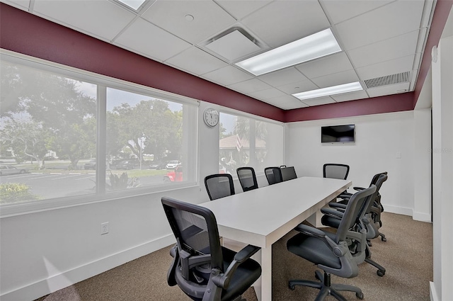 carpeted home office with a paneled ceiling