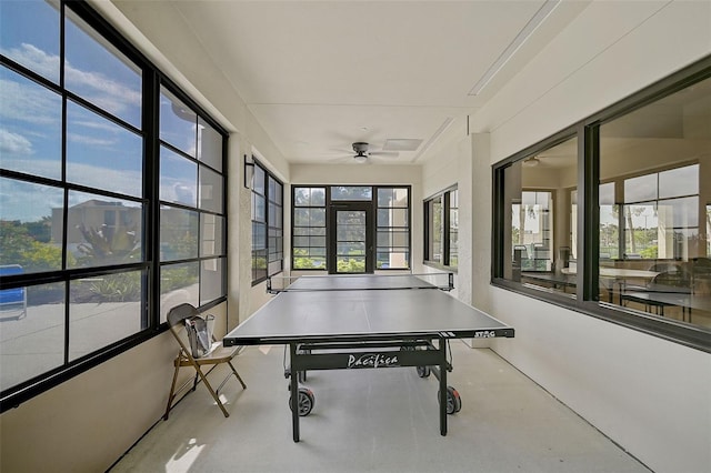 sunroom featuring ceiling fan and a healthy amount of sunlight