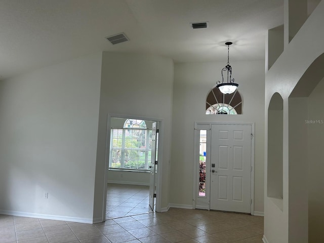 tiled entryway with a high ceiling