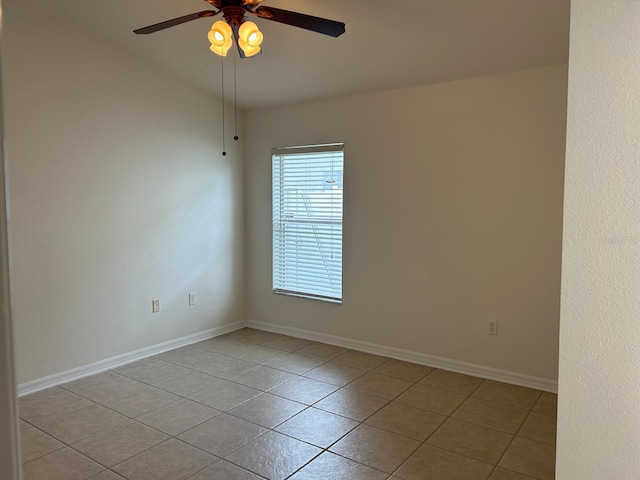 tiled empty room featuring ceiling fan