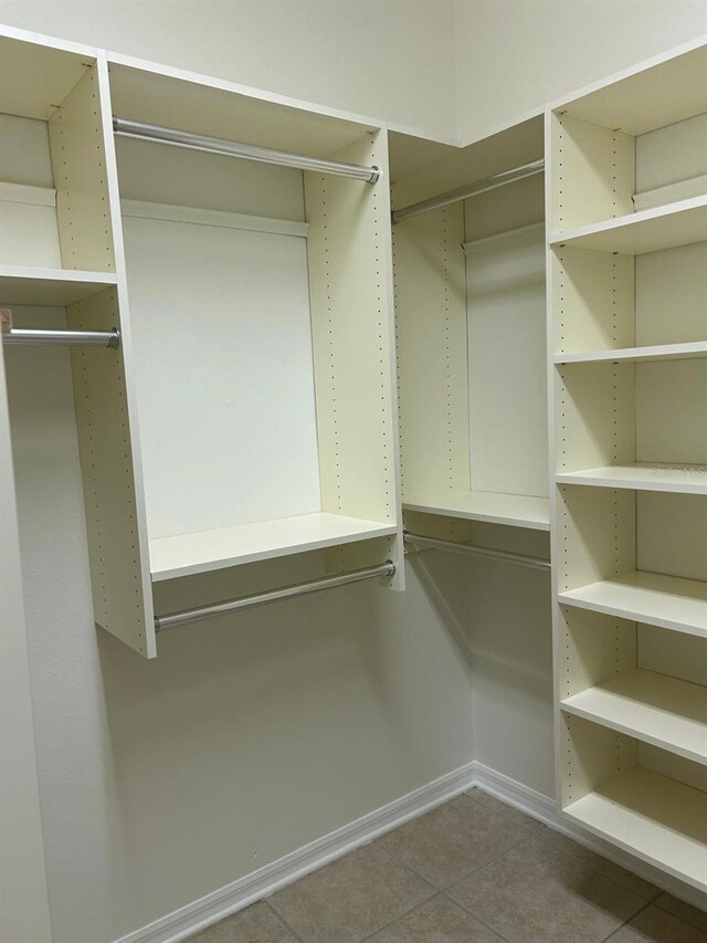 spacious closet with light tile patterned floors