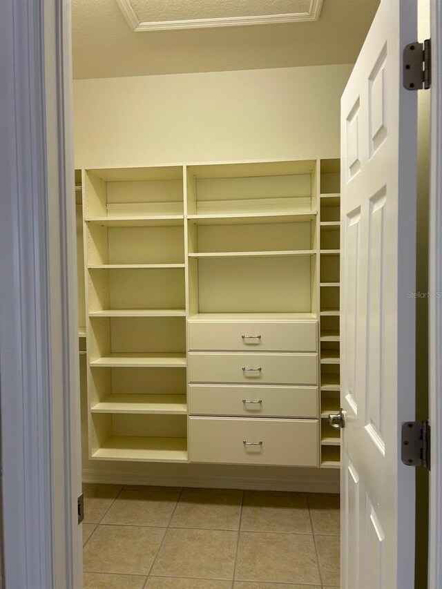 spacious closet featuring light tile patterned flooring