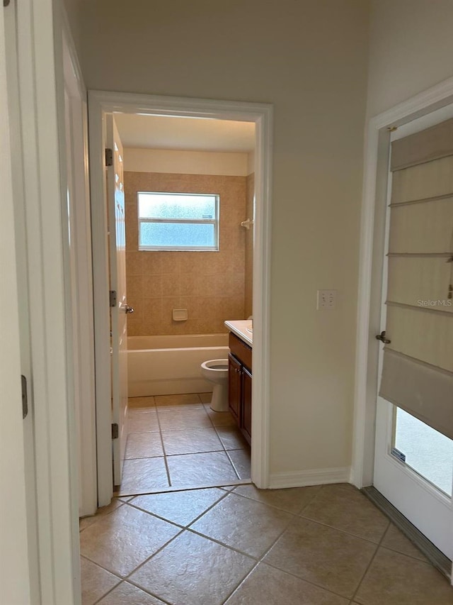 full bathroom featuring tile patterned floors, toilet, vanity, and tiled shower / bath