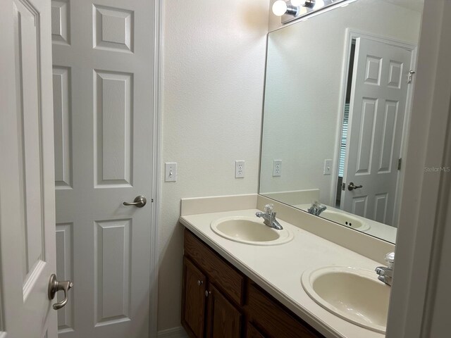 bathroom featuring dual bowl vanity