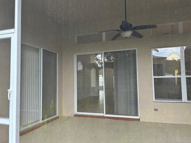 doorway to property with a patio and ceiling fan