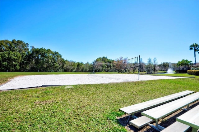 view of community featuring volleyball court and a yard