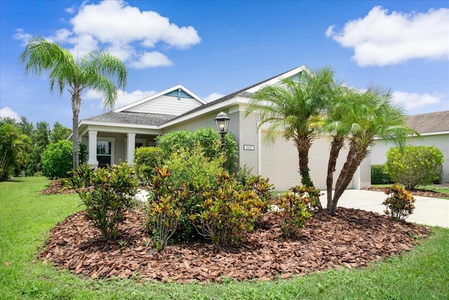 view of front of property with a front yard and a garage