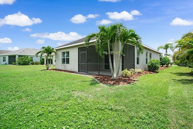 rear view of house featuring a yard