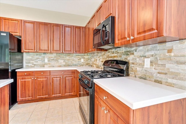 kitchen featuring light tile patterned floors, black appliances, and tasteful backsplash