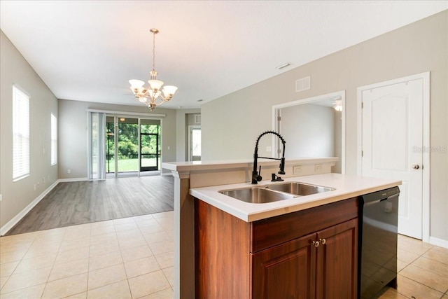 kitchen with black dishwasher, pendant lighting, a center island with sink, and sink