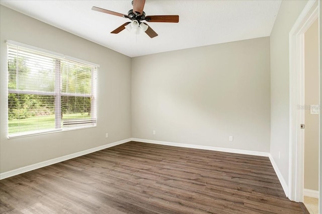 unfurnished room with ceiling fan and dark wood-type flooring