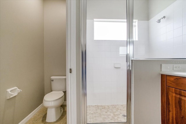 bathroom featuring a shower with shower door, toilet, and vanity