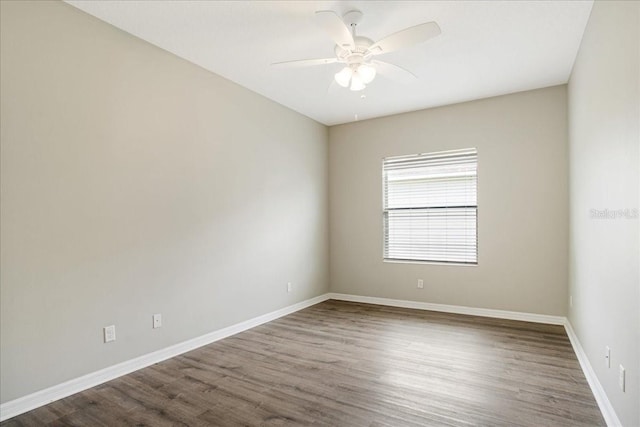 unfurnished room with ceiling fan and dark hardwood / wood-style floors