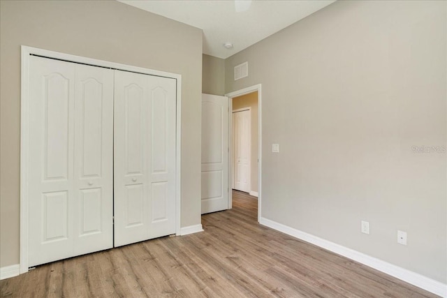 unfurnished bedroom featuring a closet and light hardwood / wood-style floors