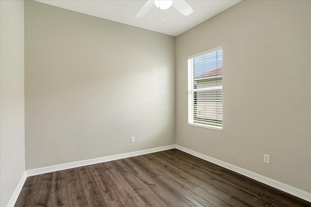 spare room with ceiling fan and dark wood-type flooring