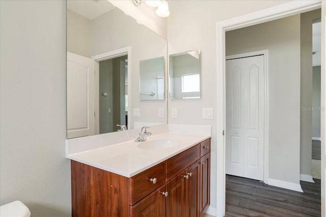 bathroom with hardwood / wood-style flooring and vanity