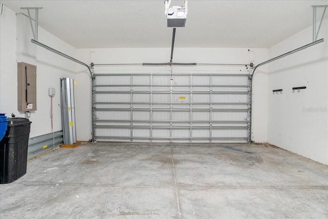 garage featuring a garage door opener and electric panel