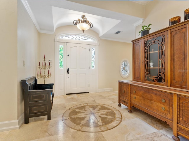 foyer entrance featuring crown molding