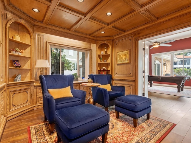 sitting room with a wealth of natural light, ceiling fan, light hardwood / wood-style floors, and coffered ceiling