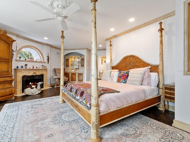 bedroom featuring dark hardwood / wood-style floors, ceiling fan, and ornamental molding