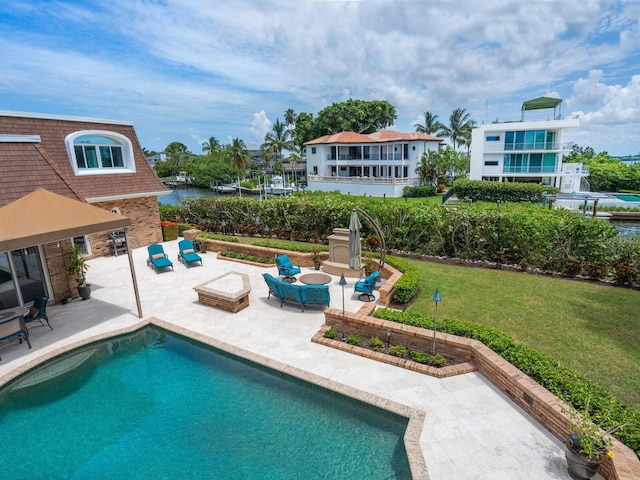 view of pool featuring a lawn, outdoor lounge area, and a patio