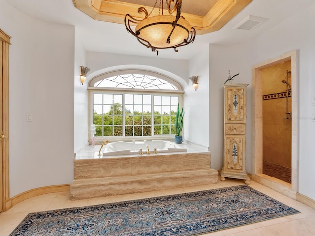 bathroom with tile patterned floors, a raised ceiling, and shower with separate bathtub