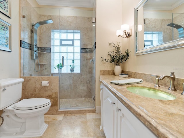 bathroom with vanity, toilet, ornamental molding, and walk in shower