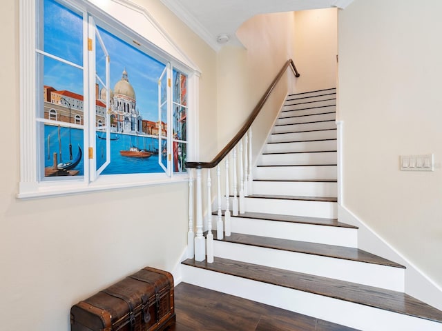 stairway featuring crown molding and hardwood / wood-style flooring