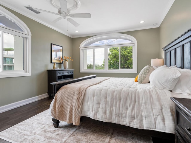 bedroom with ornamental molding, ceiling fan, and dark wood-type flooring