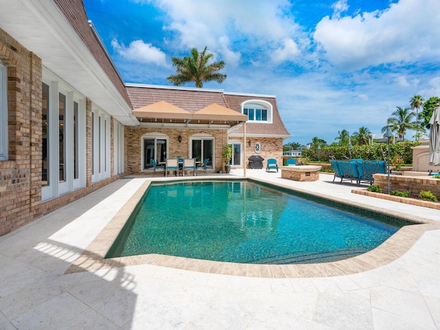 view of pool featuring an outdoor living space and a patio area