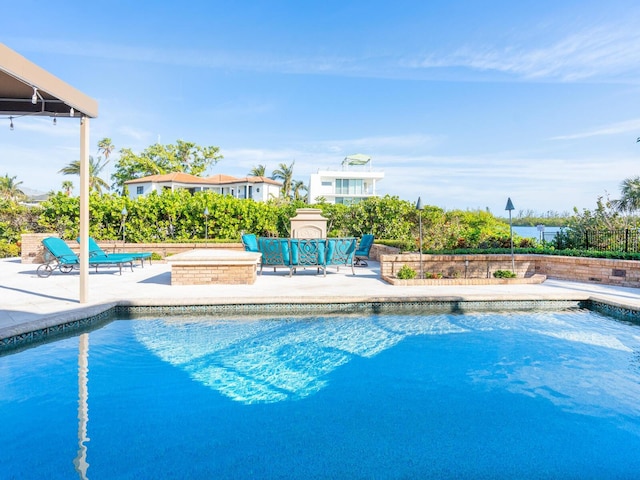 view of swimming pool with a jacuzzi and a patio