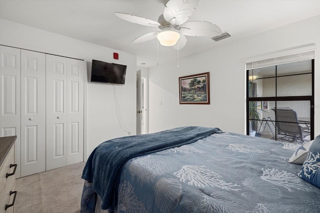 carpeted bedroom featuring a closet and ceiling fan