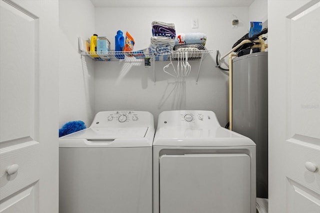 washroom featuring washing machine and clothes dryer and water heater