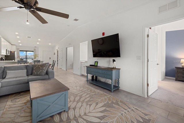 carpeted living room featuring lofted ceiling and ceiling fan