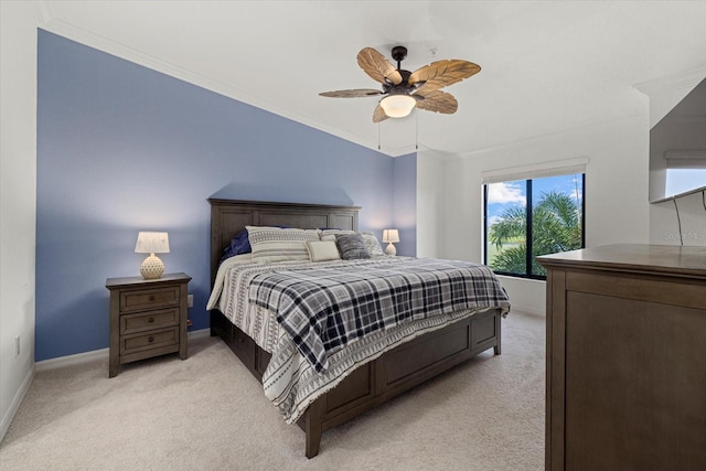 bedroom with light colored carpet, ornamental molding, and ceiling fan