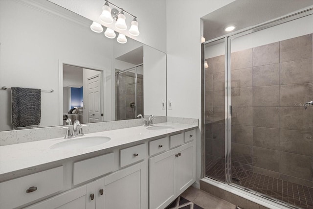 bathroom featuring dual vanity, tile patterned floors, crown molding, and an enclosed shower