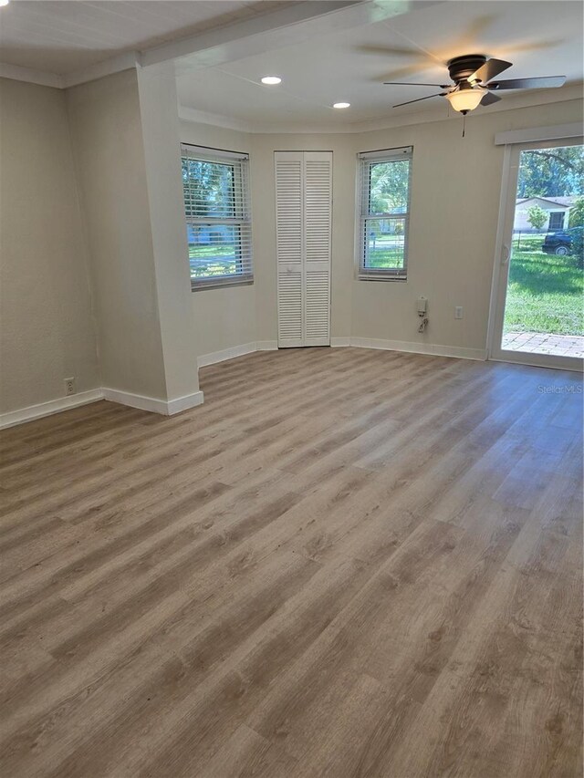 unfurnished room with ceiling fan, crown molding, and hardwood / wood-style flooring