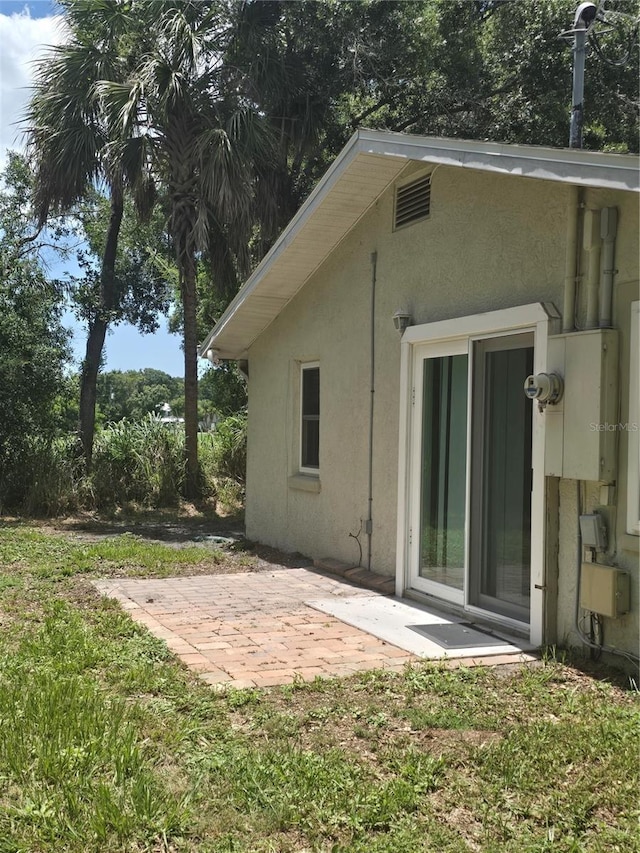 back of property with a patio