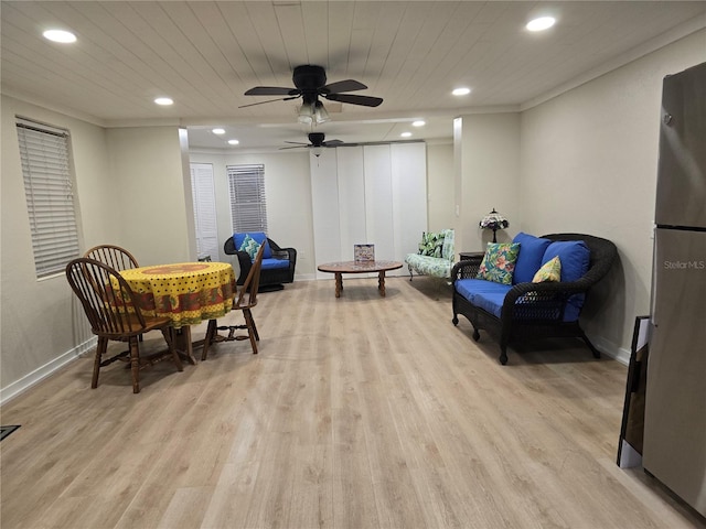 living area featuring ceiling fan and light hardwood / wood-style flooring