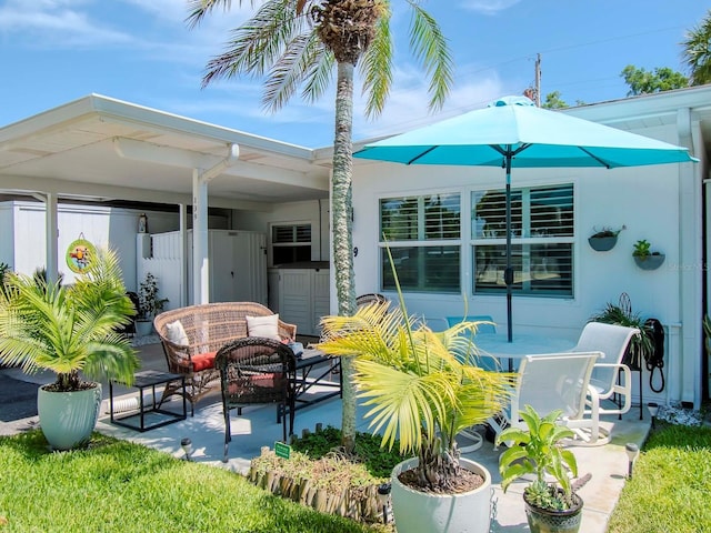 rear view of property featuring an outdoor living space and a patio area