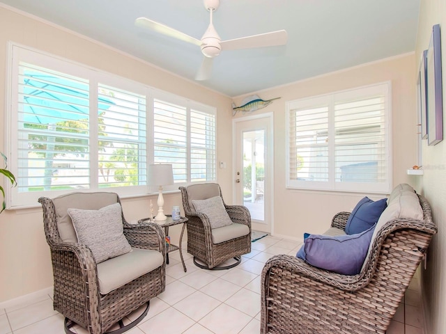 living area featuring ceiling fan, light tile patterned floors, and crown molding