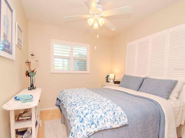 bedroom with ceiling fan and light hardwood / wood-style flooring