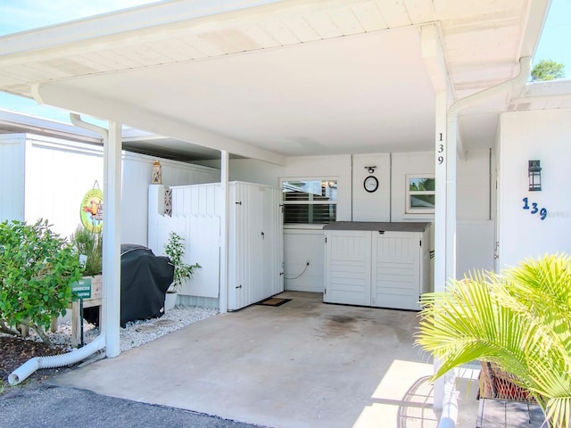 exterior space with a grill and a carport