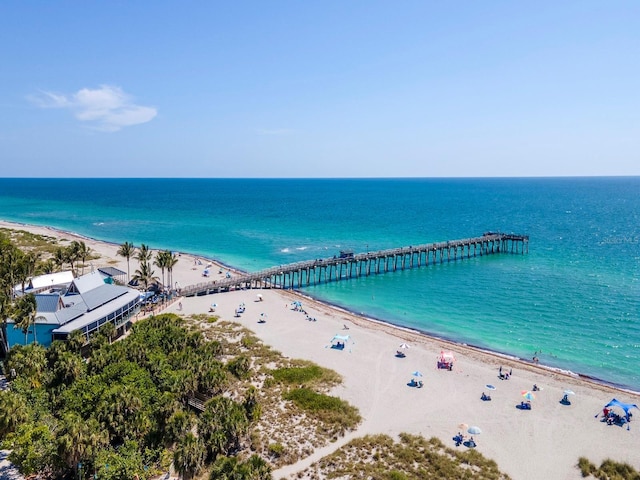 birds eye view of property with a beach view and a water view