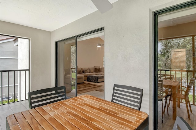 dining space featuring light tile patterned flooring and ceiling fan