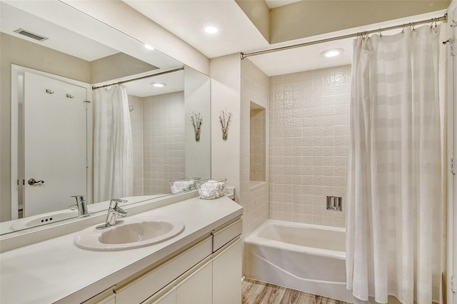 bathroom with vanity, hardwood / wood-style flooring, and shower / bath combo