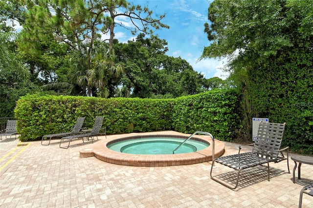 view of pool with a patio and a community hot tub