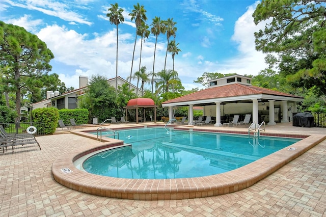 view of swimming pool featuring a patio area and a gazebo