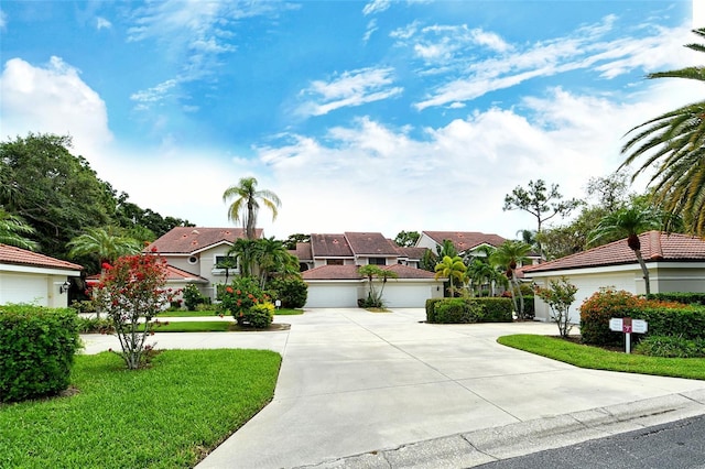 7673 Fairway Woods Dr Unit 706, Sarasota, FL 34238 - mediterranean / spanish home with a front lawn, driveway, a residential view, and a garage